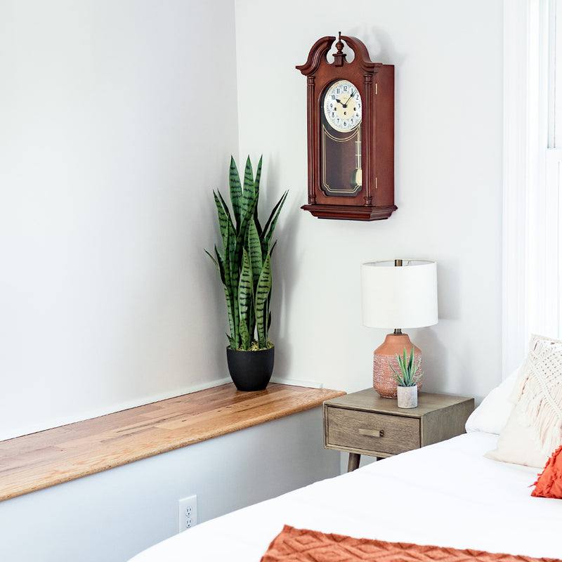 Hopewell wooden vintage style wall clock by Hermle in bedroom scene.