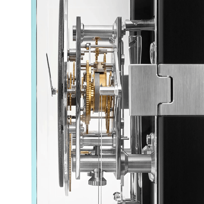 Close-up of a complex mechanical clock with visible gears and components.