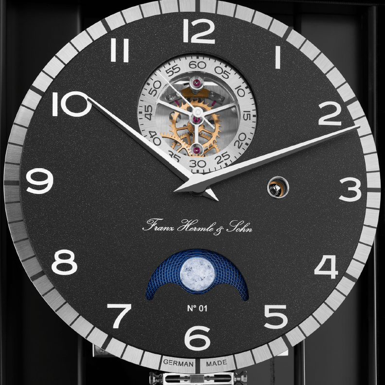 Limited edition luxury wall clock with dark clock face and gears.