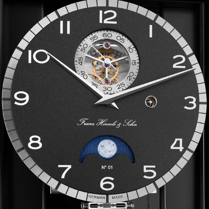Limited edition luxury wall clock with dark clock face and gears.