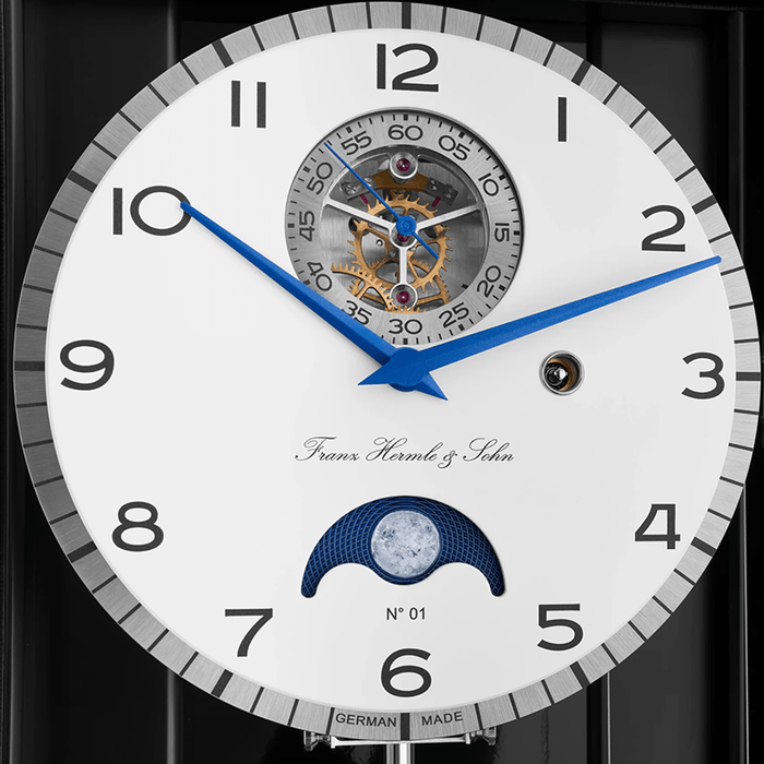 Close-up of a luxury watch face with intricate design and Franz Hermle and Sohn brand name.