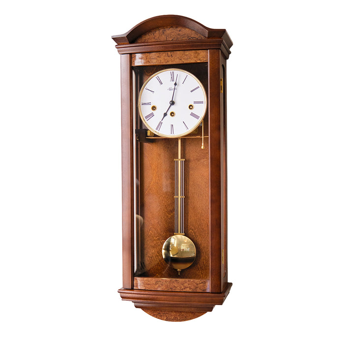 Wooden wall clock with roman numeral face and brass highlights