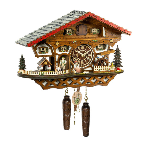 Wooden cuckoo clock with green shutters and farmer figurine on white background.