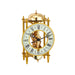 Brass mantel clock with visible intricate gears on white background