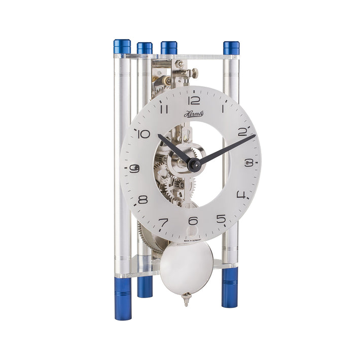 Silver and blue mechanical clock with glass face on white background