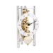Silver and brass mechanical clock with metal face and intricate gears visible on white background