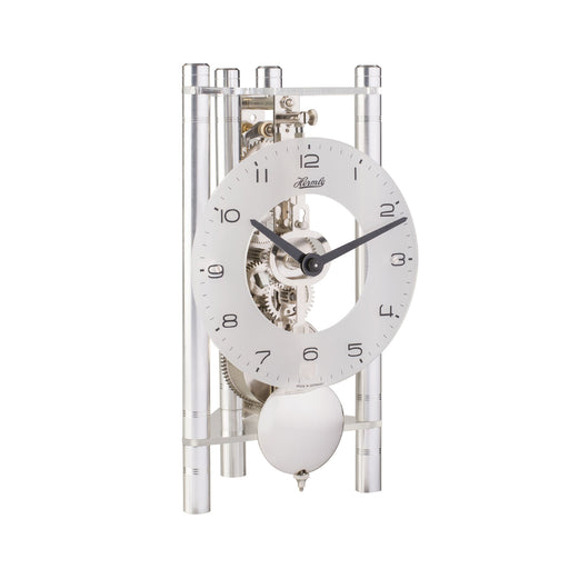 Silver mechanical clock with glass face on white background