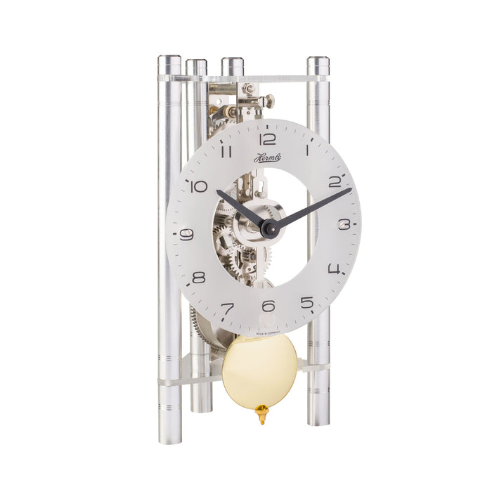 Silver mechanical clock with glass face and brass pendulum on white background