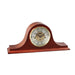 Cherry wood mantel clock with brass face and ornate hands on white background.