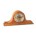 Light oak wood mantel clock with brass face and ornate hands on white background.