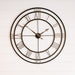 Large round wall clock with black frame and Roman numerals on a white wooden background