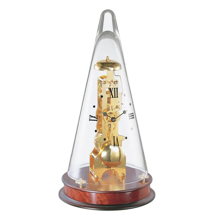 Conical decorative clock with brass gearing visible beneath glass dome, sitting on mahogany wood base