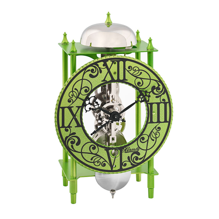 Green skeleton desk clock with roman numeral face and exposed silver gears on white background.