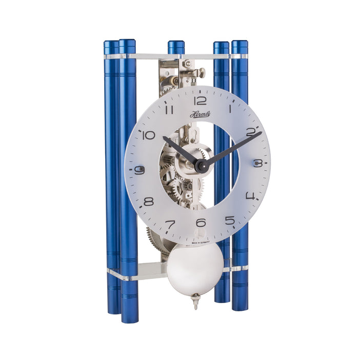 Blue and silver clock with glass face and visible intricate gears