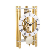Golden metal clock with roman numerals on the clock face and visible intricate gears.