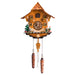 Front view of intricate wooden cuckoo clock with gnomes and detailed tree on white background 