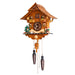 Angled view of intricate wooden cuckoo clock with gnomes and detailed tree
