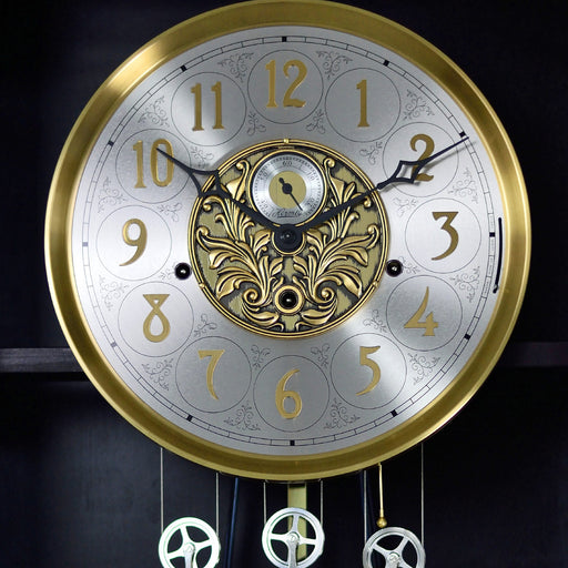 Up close of brass and nickel grandfather clock face