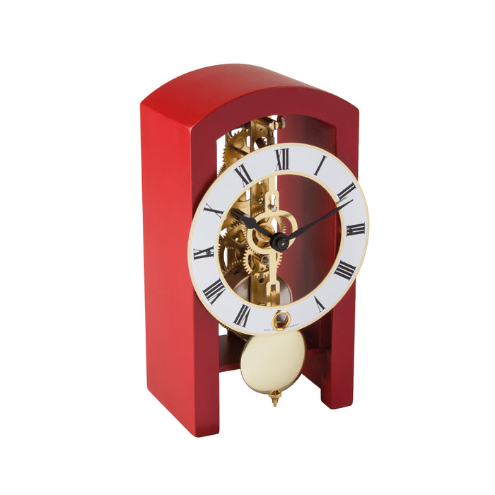 Mechanical clock with red casing and silver face on a white background