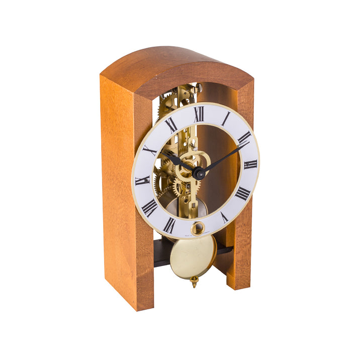 Mechanical clock with light cherry casing and silver face on a white background