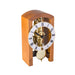 Mechanical clock with light cherry casing and silver face on a white background
