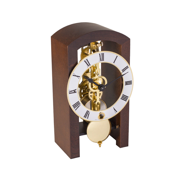 Mechanical clock with walnut casing and silver face on a white background
