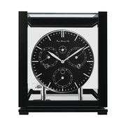 Front view of black perpetual calendar clock with black face and glass panels on white background.