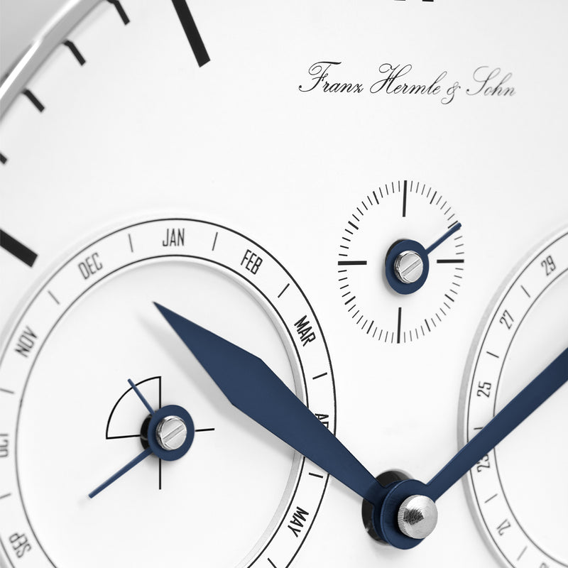 Close up of detailed clock face with calendar dial and seconds dial.