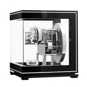 Intricate gears inside glass paneled black and silver perpetual calendar clock.