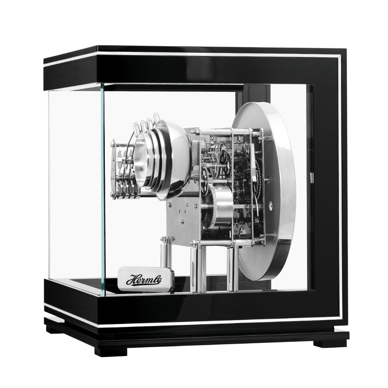 Intricate gears inside glass paneled black and silver perpetual calendar clock.