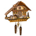 Detailed wooden cuckoo clock with house design and small train on one side, with roman numeral face and Made In Germany marking