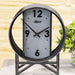 Decorative metal table clock with a circular design on a light background