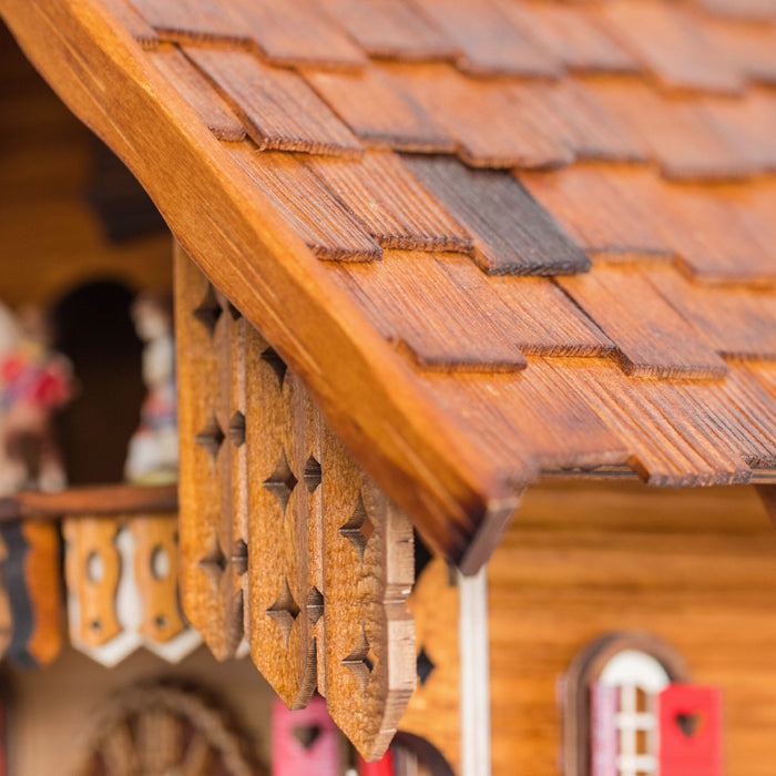 Close up of wooden shutters on the roof of decorative cuckoo clock 