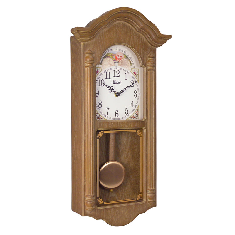 Wooden wall clock with brass finish pendulum and illustrated moon dial on white background.