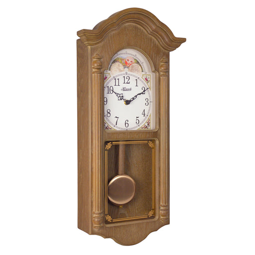 Wooden wall clock with brass finish pendulum and illustrated moon dial on white background.