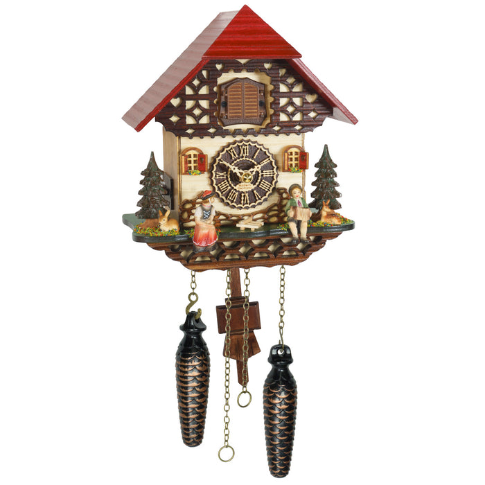 Decorative cuckoo clock with wooden house design and roman numeral face on a white background