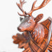 Close-up of wooden deer head mounted on top of cuckoo clock