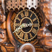 Close-up of a wooden cuckoo clock with intricate carvings and a detailed face.