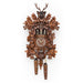 Wooden cuckoo clock with intricate carved leaves and animals around roman numeral face