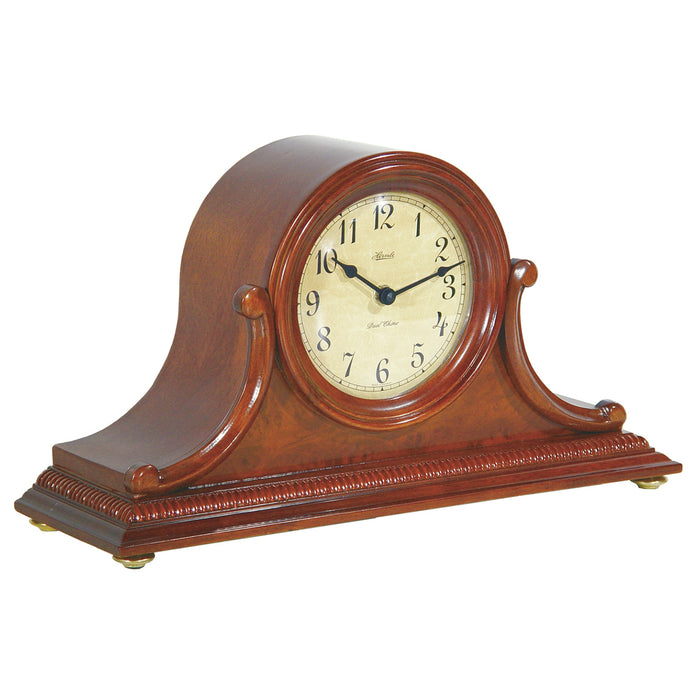 Cherry wood Tambour style mantel clock with ornate design and Hermle logo on face. 