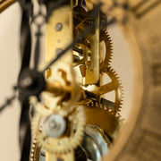 Close up of brass gears inside a skeleton clock.