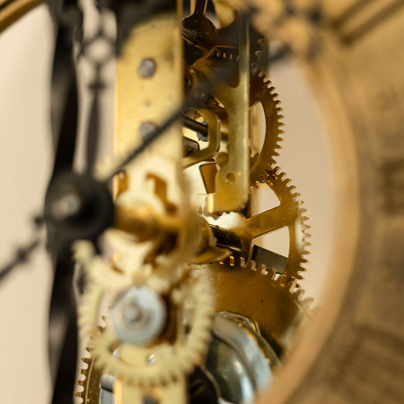Close up of brass gears inside a skeleton clock.