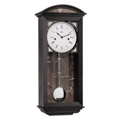 Black wood wall clock with nickel pendulum and two holes in the face for winding the mechanical movement inside.