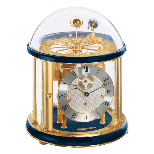Blue and brass Tellurium clock with glass dome and brass plated mechanical gears visible on white background.