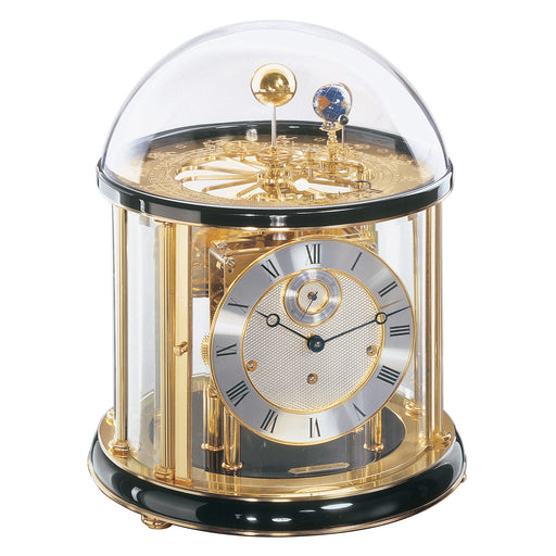 Black and brass Tellurium clock with glass dome and brass plated mechanical gears visible on white background.