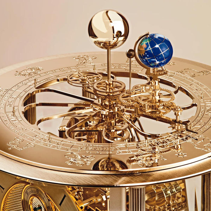 Gold mechanical clock gears with intricate design and globe on a beige background