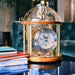 Cherry wood and brass Tellurium clock with glass in living room on blue table.