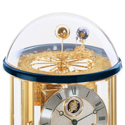 Glass Tellurium dome with brass Sun and Earth globes mounted on intricate gears on white background.
