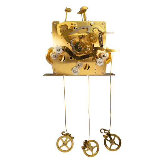 Front of a brass clock movement with gears and hanging wires on white background.