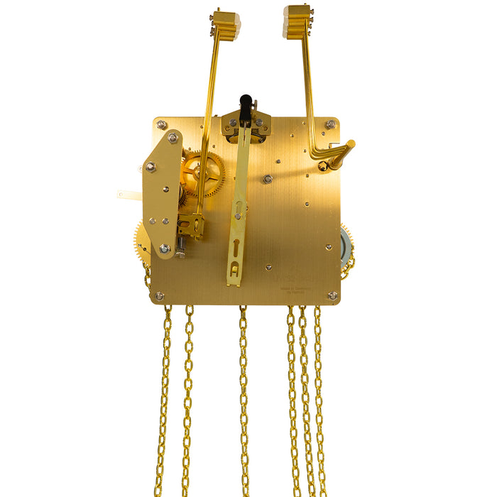 Brass clock movement with visible gears, hanging chains and hammers on white background.